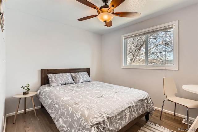 bedroom with ceiling fan and dark hardwood / wood-style flooring