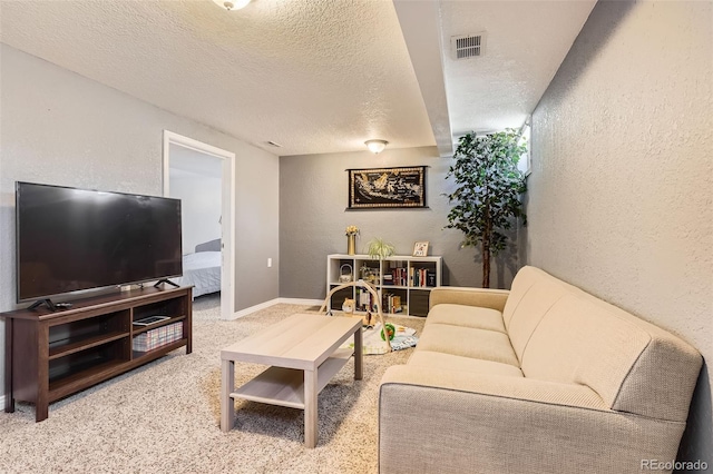 living room featuring carpet floors and a textured ceiling