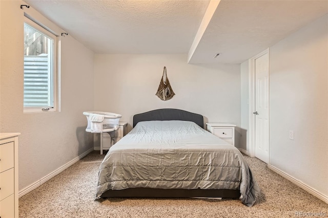 carpeted bedroom with a textured ceiling