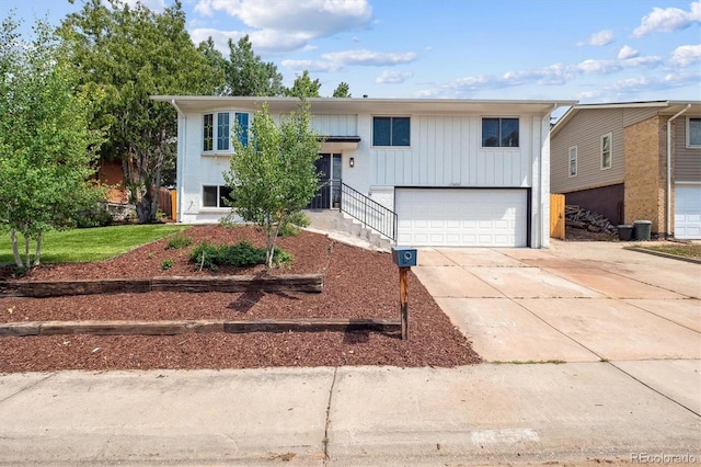 13051 W Jewell Cir, Lakewood, CO 80228 - bi-level home featuring a garage and concrete driveway