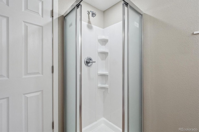 13051 W Jewell Cir, Lakewood, CO 80228 - full bathroom with a stall shower and a textured wall