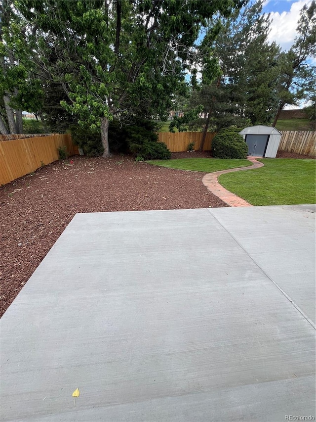 13051 W Jewell Cir, Lakewood, CO 80228 - fenced backyard with a patio and a shed