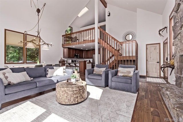 20223 Goins Dr, Morrison, CO 80465 - living room featuring high vaulted ceiling, wood-type flooring, a chandelier, stairway, and beamed ceiling