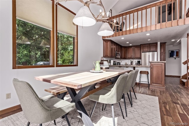 20223 Goins Dr, Morrison, CO 80465 - dining space featuring a chandelier, dark wood finished floors, and a towering ceiling