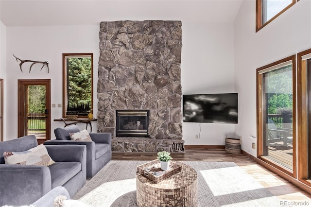20223 Goins Dr, Morrison, CO 80465 - living room featuring a fireplace and wood finished floors
