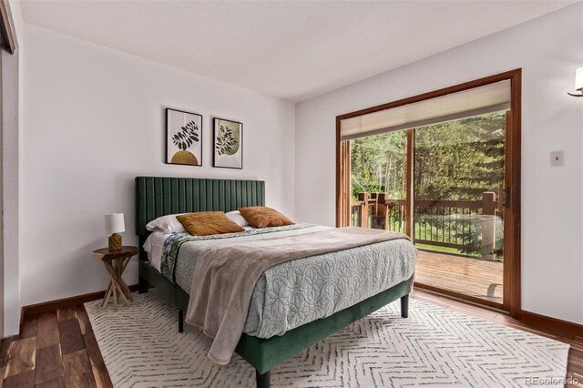 20223 Goins Dr, Morrison, CO 80465 - bedroom with access to exterior and wood finished floors