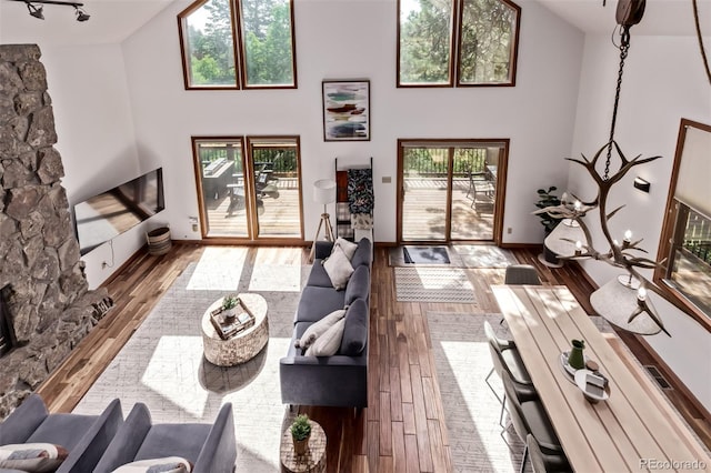 20223 Goins Dr, Morrison, CO 80465 - living room featuring hardwood / wood-style floors and a towering ceiling