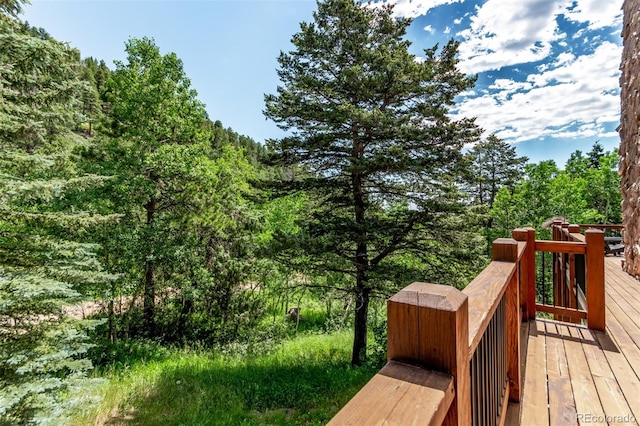 20223 Goins Dr, Morrison, CO 80465 - wooden deck with a wooded view