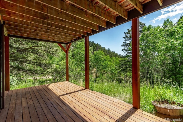20223 Goins Dr, Morrison, CO 80465 - wooden terrace featuring a wooded view
