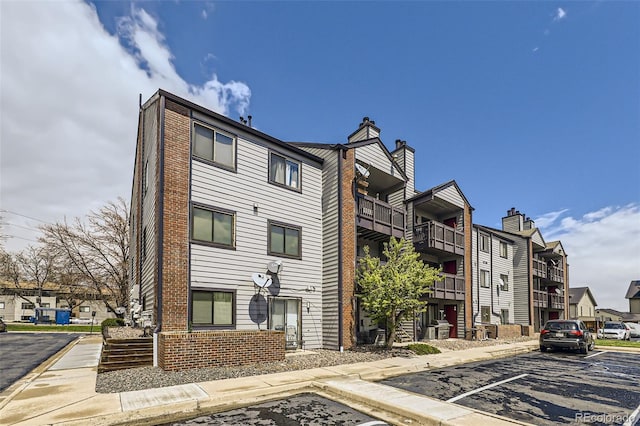 view of property featuring uncovered parking