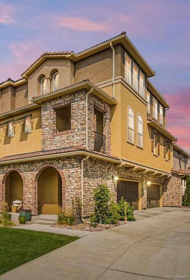 3437 Rosato Dr Unit C, Highlands Ranch, CO 80126 - property at dusk with an attached garage and driveway