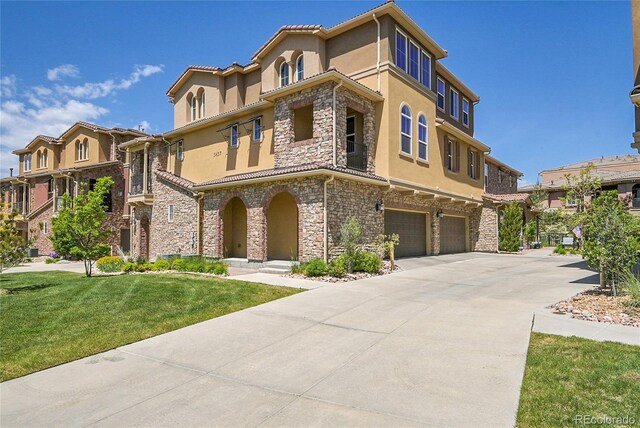 3437 Rosato Dr Unit C, Highlands Ranch, CO 80126 - view of front of property with stone siding, a garage, stucco siding, and concrete driveway