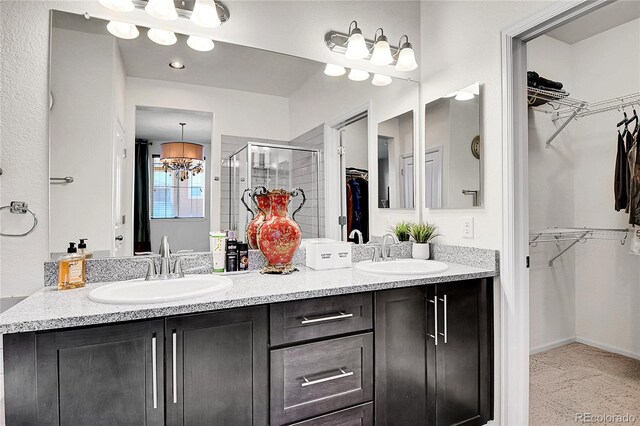 3437 Rosato Dr Unit C, Highlands Ranch, CO 80126 - full bath featuring a spacious closet, double vanity, a stall shower, and a chandelier