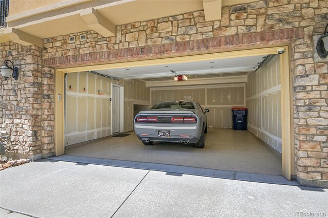 3437 Rosato Dr Unit C, Highlands Ranch, CO 80126 - garage featuring concrete driveway and a garage door opener