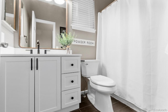 bathroom featuring vanity, toilet, and wood finish floors