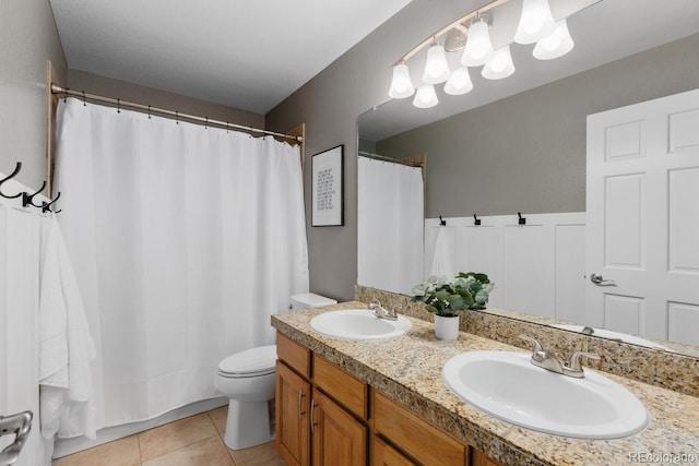 full bathroom featuring tile patterned flooring, double vanity, toilet, and a sink