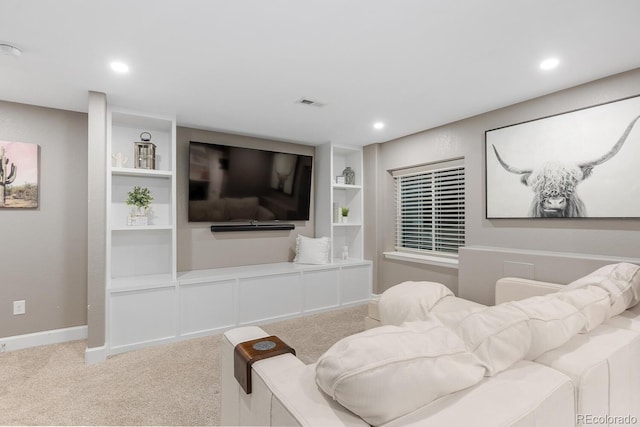 carpeted living room with built in shelves, recessed lighting, visible vents, and baseboards