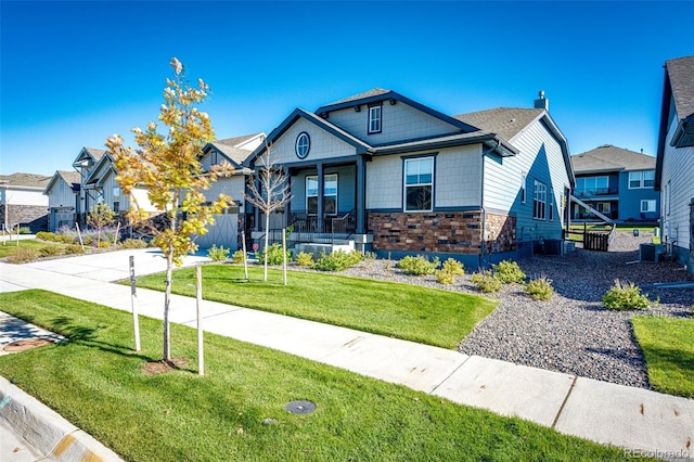 view of front facade with a front yard and central AC unit