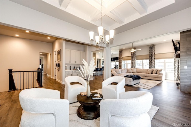 living room with coffered ceiling, beamed ceiling, wood-type flooring, and ceiling fan with notable chandelier