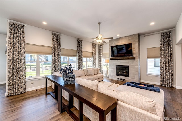 living room with ceiling fan, dark hardwood / wood-style flooring, and a fireplace