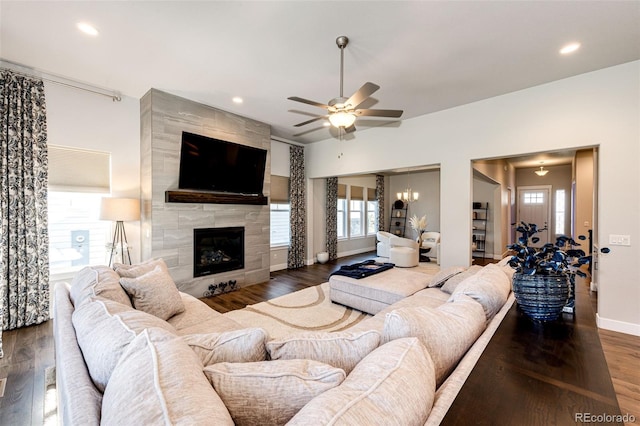 living room featuring dark hardwood / wood-style floors, ceiling fan, a tile fireplace, and a wealth of natural light