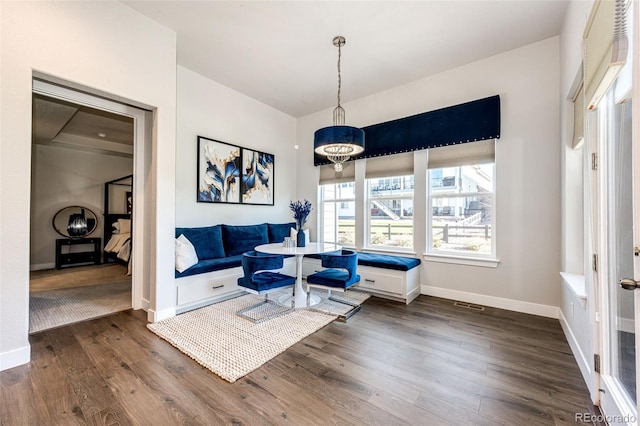 interior space featuring breakfast area and dark hardwood / wood-style flooring