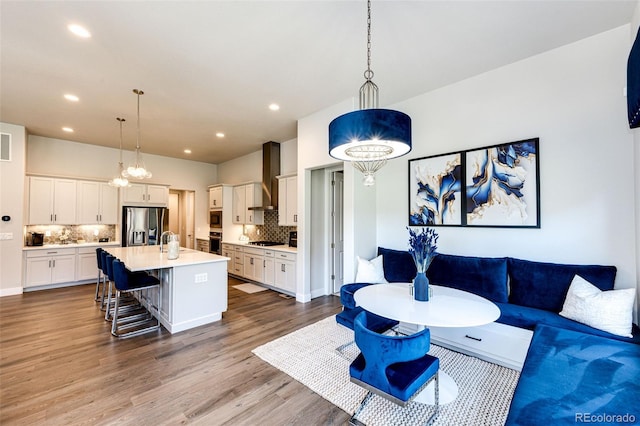 living room featuring hardwood / wood-style floors and sink