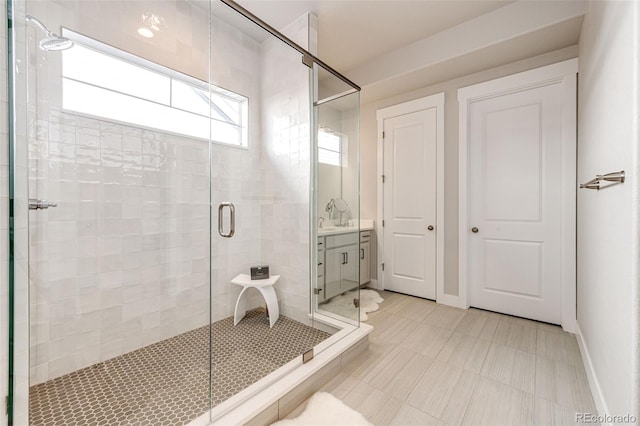 bathroom featuring vanity and a shower with shower door