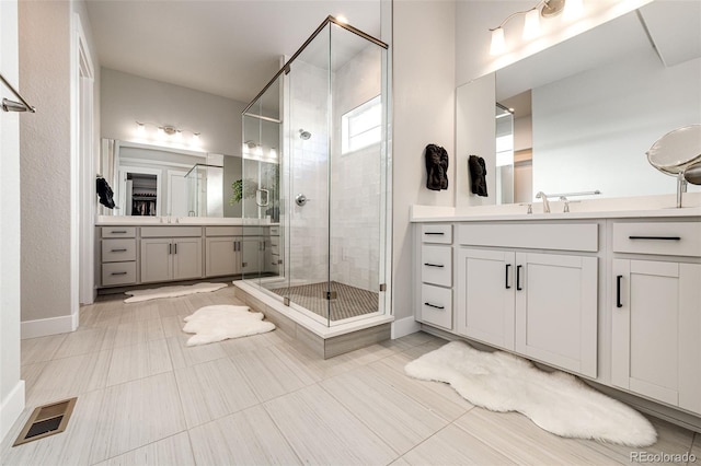 bathroom with vanity, walk in shower, and tile patterned flooring