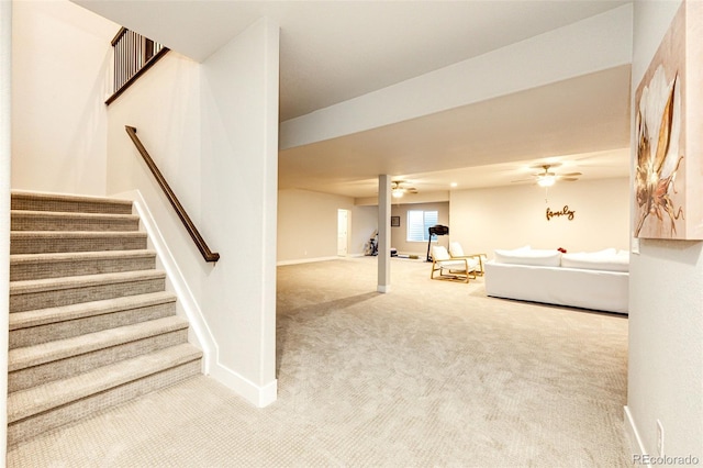 unfurnished living room with ceiling fan and carpet