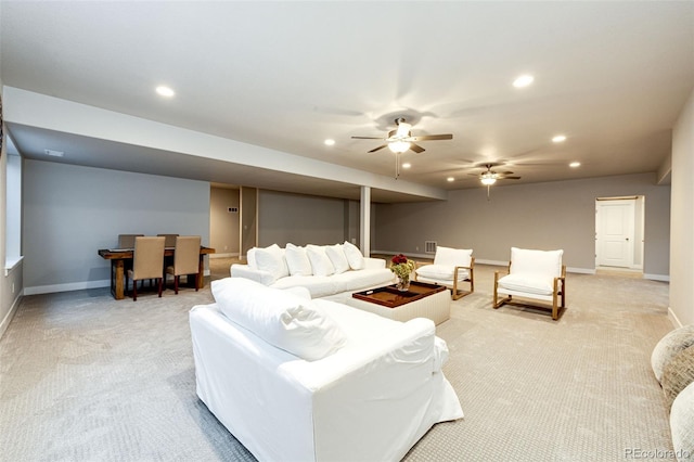 carpeted living room with ceiling fan