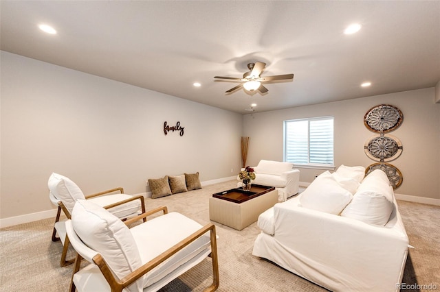 carpeted living room with ceiling fan