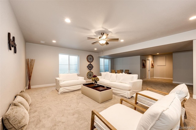 carpeted living room with ceiling fan