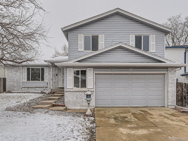 view of front of home with an attached garage, brick siding, and driveway