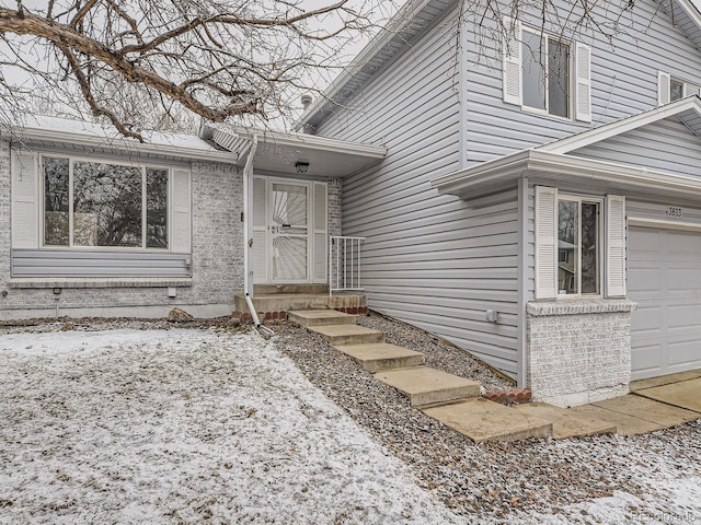 view of exterior entry with brick siding