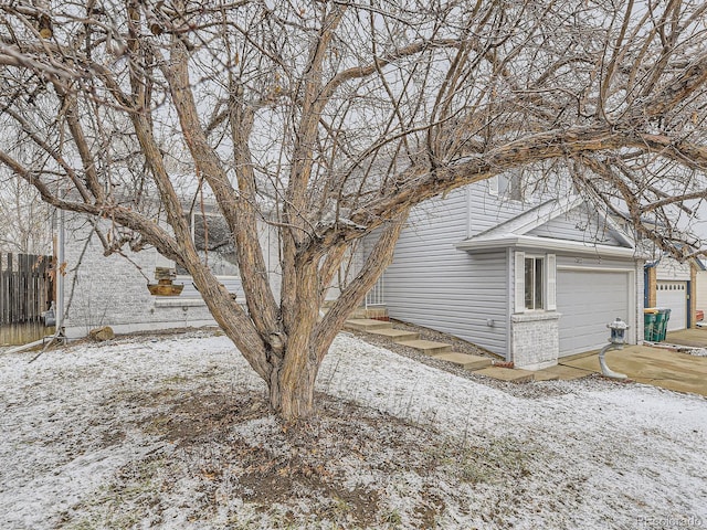 view of snow covered exterior featuring fence