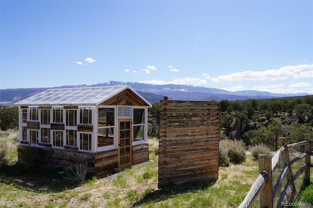 rear view of house featuring an outdoor structure and a mountain view