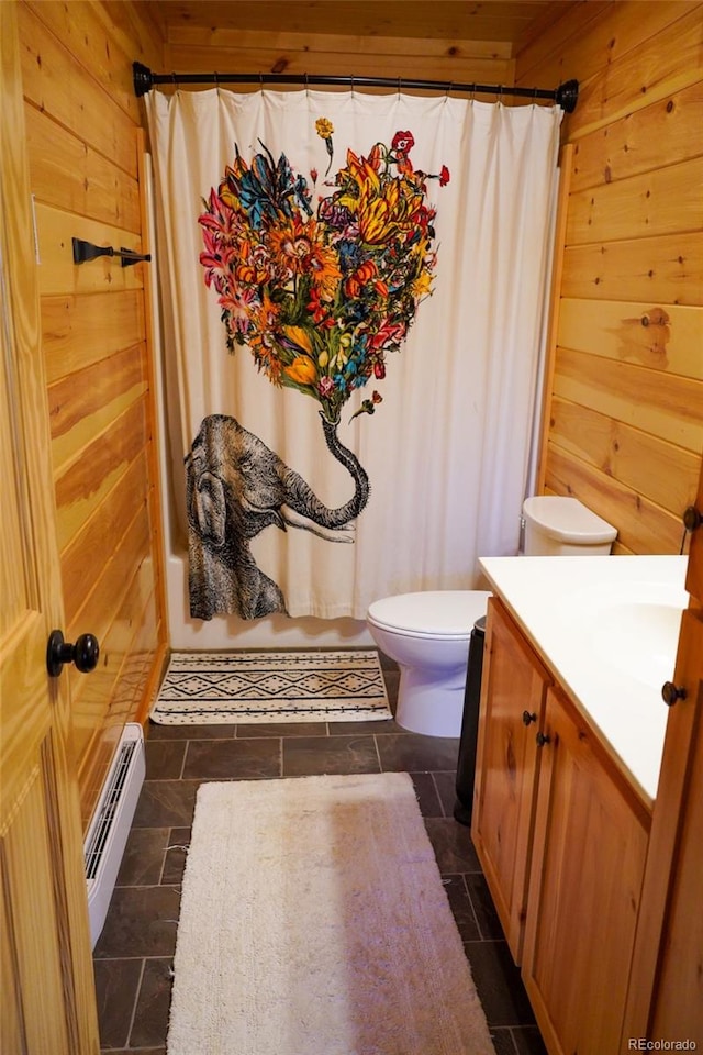 full bathroom featuring wooden walls, tile flooring, a baseboard radiator, and toilet