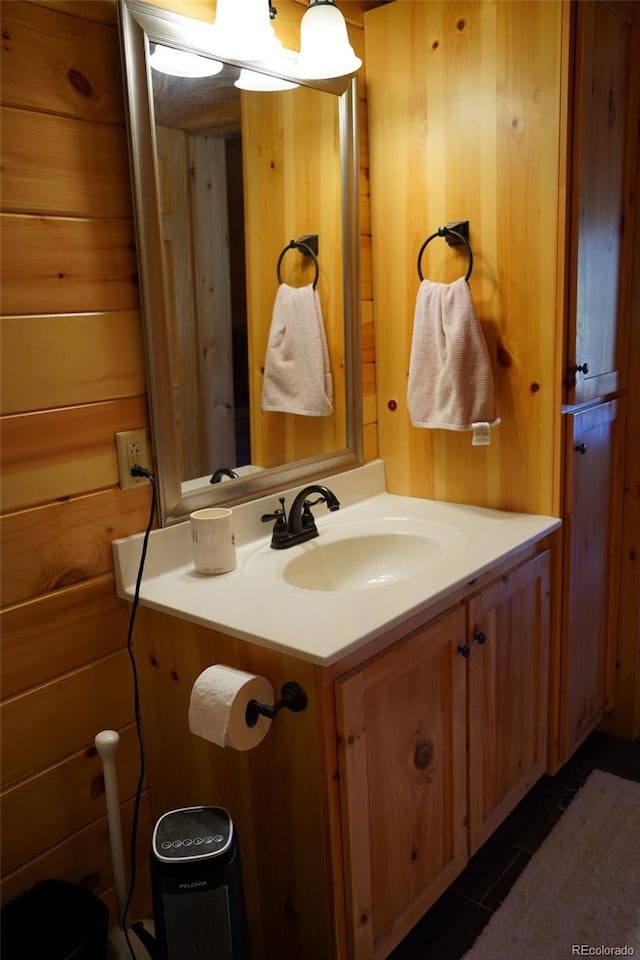 bathroom with wooden walls and vanity