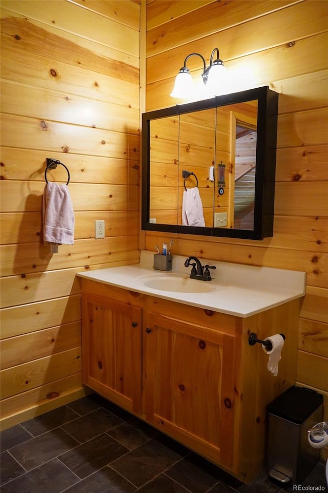 bathroom featuring wood walls, oversized vanity, and tile floors