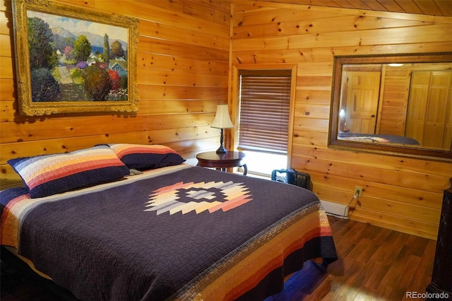 bedroom featuring dark hardwood / wood-style floors and wood walls