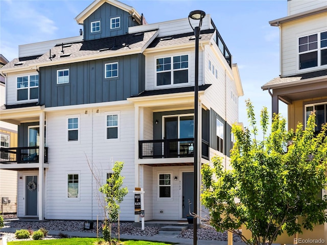 6162 W 28th Ct, Edgewater, CO 80214 - view of front of home featuring board and batten siding, a balcony, and roof mounted solar panels