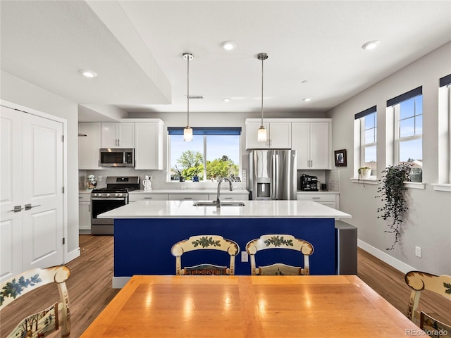 6162 W 28th Ct, Edgewater, CO 80214 - kitchen featuring stainless steel appliances, a sink, wood finished floors, plenty of natural light, and recessed lighting