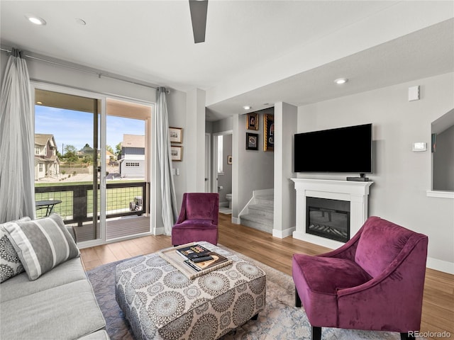 6162 W 28th Ct, Edgewater, CO 80214 - living room featuring wood finished floors, baseboards, a glass covered fireplace, and recessed lighting