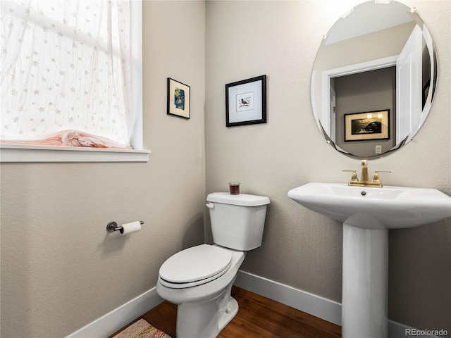 6162 W 28th Ct, Edgewater, CO 80214 - bathroom featuring wood finished floors, toilet, baseboards, and a sink