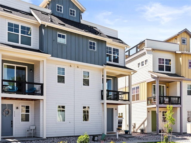6162 W 28th Ct, Edgewater, CO 80214 - rear view of house featuring board and batten siding, solar panels, and a balcony