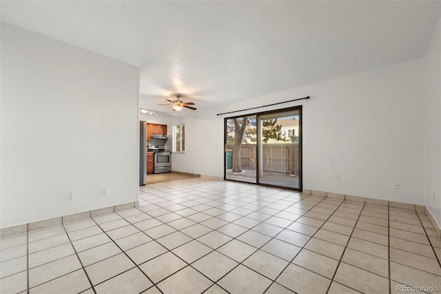 empty room featuring ceiling fan and light tile patterned floors