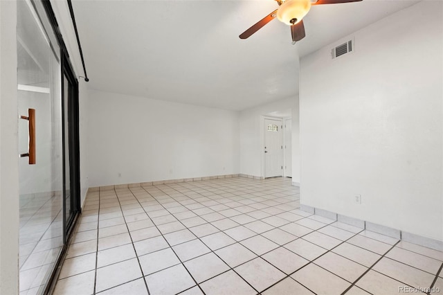 tiled empty room with ceiling fan