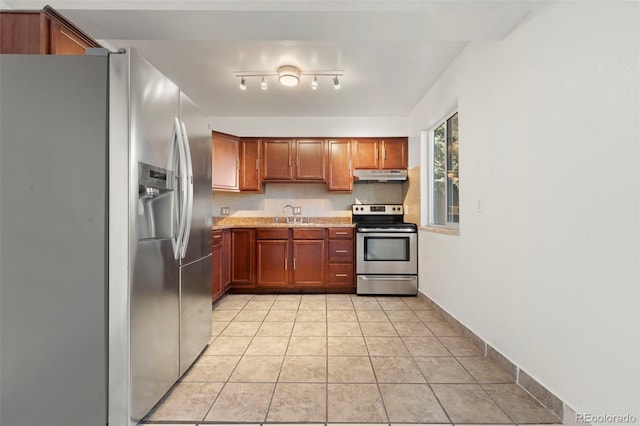 kitchen featuring sink, light tile patterned floors, backsplash, and appliances with stainless steel finishes