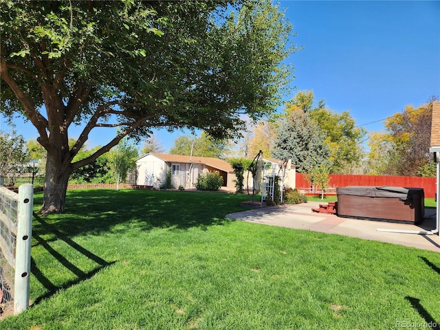 view of yard with a patio area and a hot tub